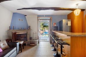 a living room with a bar and a fireplace at Porto Douro - Maison in Foz do Sousa