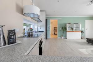 a kitchen with a counter top and a living room at Wohnung Deluxe in Heide