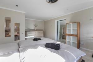 two beds in a bedroom with white walls at Wohnung Deluxe in Heide