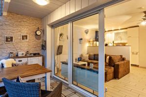 a kitchen and living room with a sliding glass door at Ferienwohnung Bergidyll in Schmallenberg +10 photos