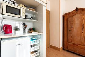 a kitchen with a refrigerator and a microwave at Charro Room in Corralejo