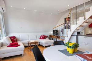 a living room with a white couch and a table at Ferienwohnung Hirschsprung Saig in Lenzkirch