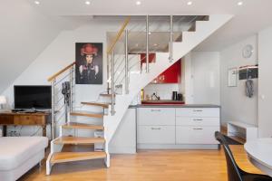 a living room with a staircase and a kitchen at Ferienwohnung Hirschsprung Saig in Lenzkirch +26 photos