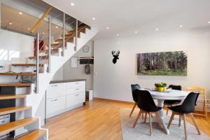 a kitchen and dining room with a table and chairs at Ferienwohnung Hirschsprung Saig in Lenzkirch