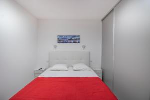 a white bedroom with a red blanket on a bed at Splendide Grand Appart Neuf in Albitreccia +19 photos