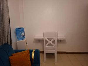a table and a chair in a living room at Bright Homes in Eldoret