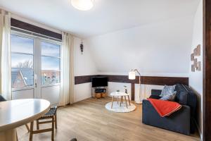 a living room with a couch and a table at Inselliebe in Pellworm