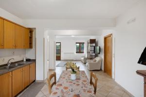 a kitchen and living room with a table with chairs at Zio Gennaro Residence in Agerola