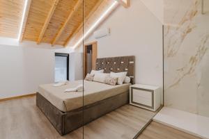 a bedroom with a bed and a glass wall at Dunas e Abraços in Braga +22 photos