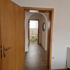 a hallway with a door leading to a bathroom at Ferienwohnung Mawitha in Roth +36 photos