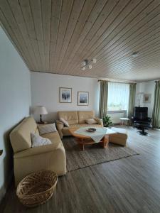 a living room with a couch and a table at Ferienwohnung Mawitha in Roth