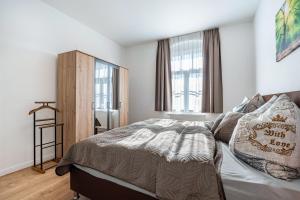 a bedroom with a bed and a large window at Villa Rathmannsdorf in Rathmannsdorf