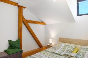 a bedroom with a bed with green pillows at Kreuzbergblick Bayerischer Wald in Hohenau