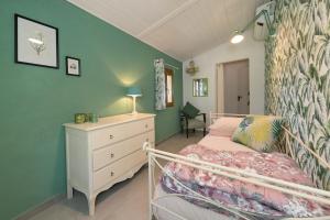 a bedroom with a bed and a dresser in it at Villa Cristina in Riparbella +36 photos
