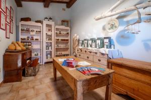 a room with a wooden table and shelves with books at La Svolta - Aria in Manciano