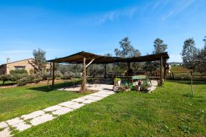 a gazebo in a grassy field with at La Svolta - Aria in Manciano +17 photos