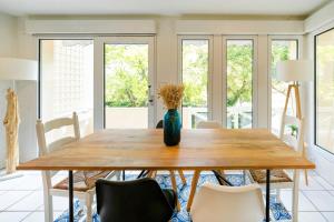 a dining room with a wooden table and chairs at Dune Lodge 1- Capbreton Hossegor - in Capbreton +21 photos
