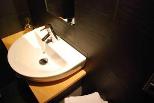 a bathroom with a white sink and a mirror at Landhaus Bornemann in Diemelsee +63 photos