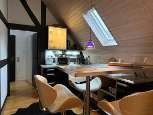 a kitchen with a table and chairs in a room at Landhaus Bornemann in Diemelsee