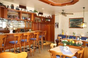 a restaurant with a bar with wooden chairs and tables at Ferienwohnung Lisa in Medebach
