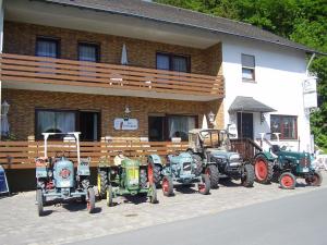 a group of tractors parked in front of a building at Ferienwohnung Lisa in Medebach