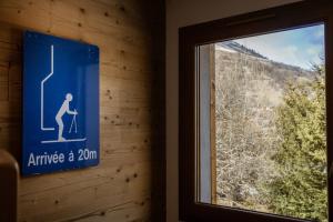 a sign on a wall next to a window at Chalet Lova in Valloire