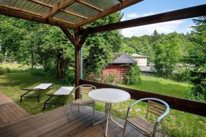 a porch with a table and chairs on a deck at Krüseliner Mühle - Appartements in Krüselin