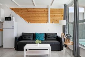 a living room with a couch and a table at Loft Amanecer in Mácher