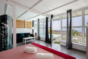a living room with a view of the ocean at Loft Amanecer in Mácher +12 photos