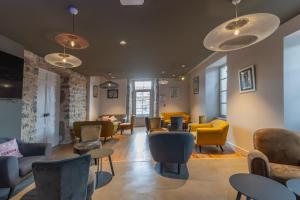 a waiting room with couches and chairs at Merlot in Ruoms