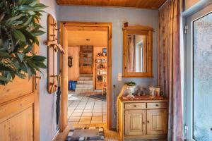 a hallway of a home with a wooden door at Pension Schlachter's Hius in Algermissen +26 photos