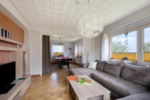 a living room with a couch and a table at Gästehaus Tadenswarf in Tadenswarf