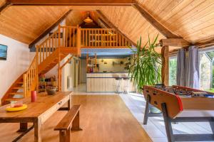a room with a table and a ping pong table at Loft Atypique jacuzzi sauna in Cléguérec