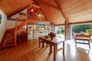 a living room with a wooden staircase in a house at Loft Atypique jacuzzi sauna in Cléguérec