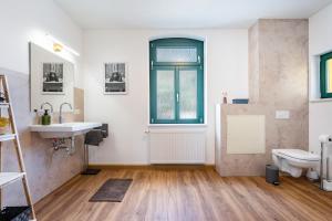 a bathroom with a sink and a toilet at Villa Rathmannsdorf in Rathmannsdorf +142 photos