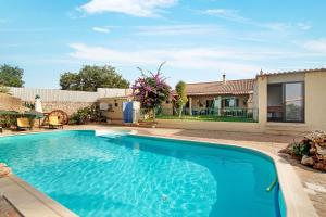 a swimming pool in front of a house at Casa Rústica in Silves