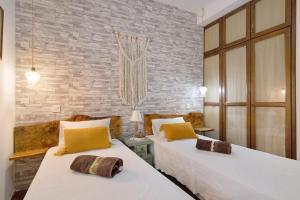 two beds in a room with brick walls at Casa Rústica in Silves +30 photos