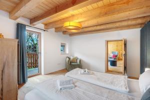 a bedroom with a bed and a large window at Alpin Chalet Samer Apt Bauernstube in Sarntal