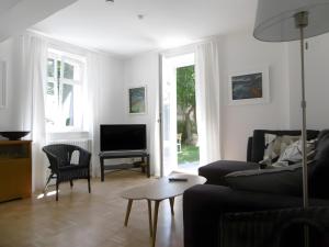 a living room with a couch and a tv at Schlößleweg 2a in Bodman-Ludwigshafen