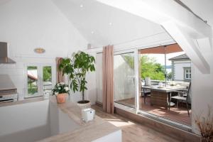 a kitchen and dining room with a table and a large window at Haus Behr am See in Radolfzell am Bodensee