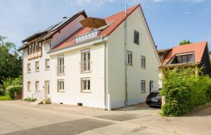 a large white house with a red roof at Haus Behr am See in Radolfzell am Bodensee