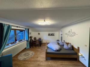 a bedroom with a bed with blue pillows on it at Aschaubichl - Wohnung Narzisse in Grainau