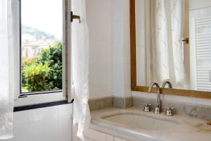 a bathroom with a sink and a window at Chéz Dede in Levanto +16 photos
