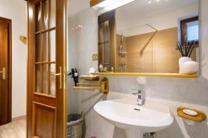 a bathroom with a sink and a mirror at Maison Sylvie Pila in Gressan +68 photos