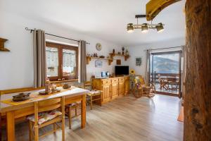 a kitchen with a table and a dining room at Maison Sylvie Pila in Gressan