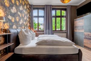 a bedroom with a bed and a large window at Gästezimmer St Wendel in Prüm +131 photos