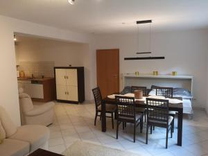 a kitchen and dining room with a table and chairs at Ferienwohnung Mössingen in Mössingen