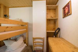 a room with two bunk beds and a wooden table at Ferienhaus Lausekuppe Neustadt in Neustadt +12 photos