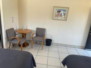 a room with a table and two chairs and a table at Hotel Ranchito in Ensenada +5 photos