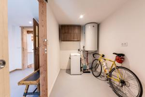 a bike parked in a room with a kitchen at Appartement Des Fontaines Albiez in Albiez-le-Jeune